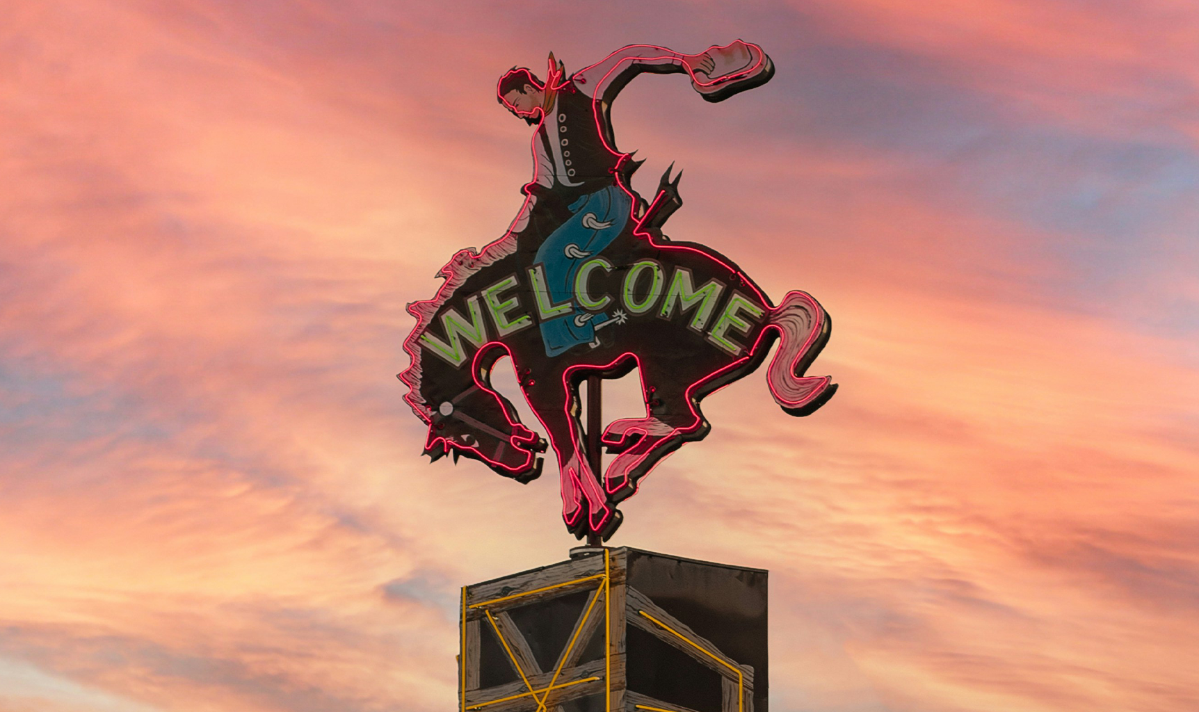Illuminated Welcome Sign of a Cowboy Riding a Horse