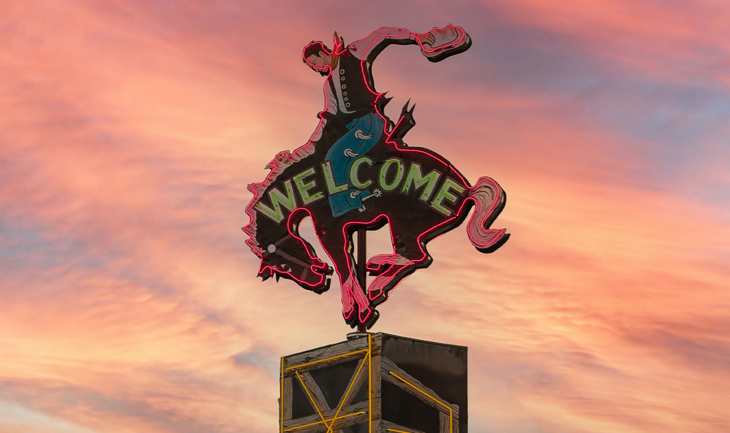 Illuminated Welcome Sign of a Cowboy Riding a Horse