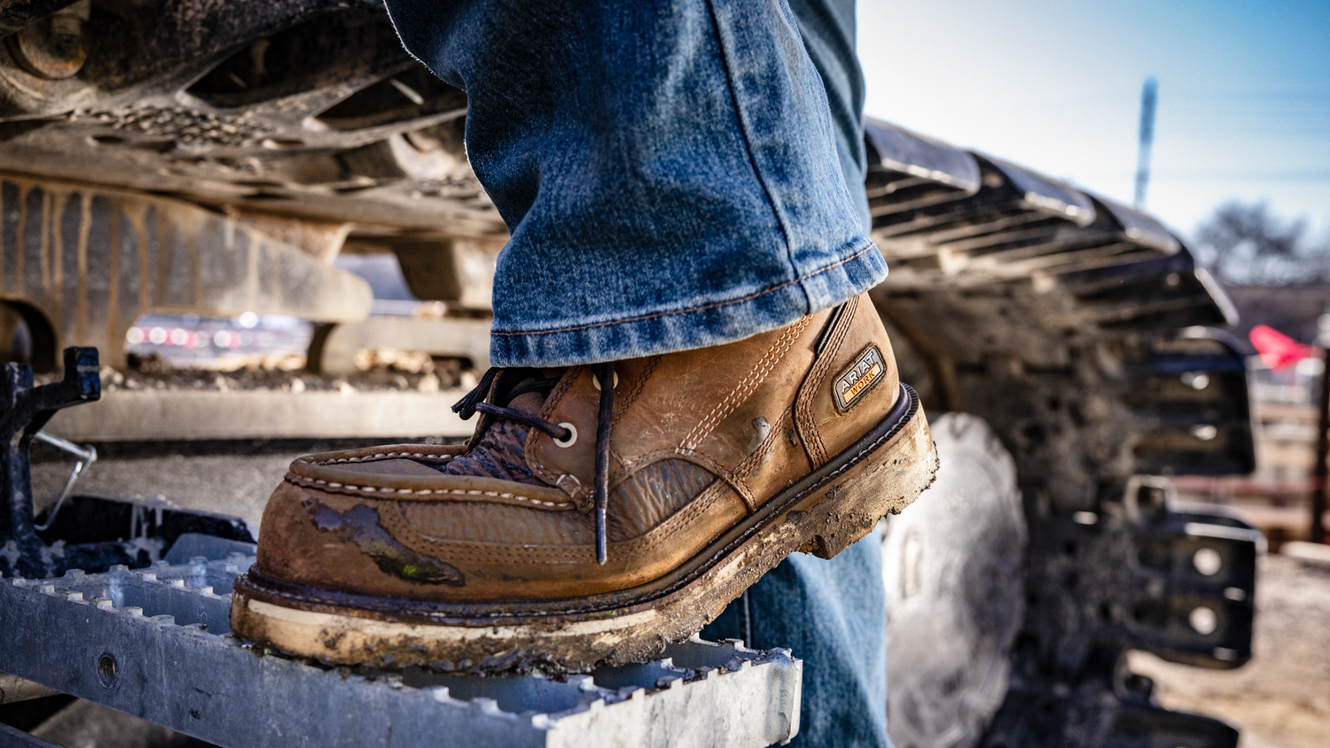 Man wearing work boots entering a construction machine